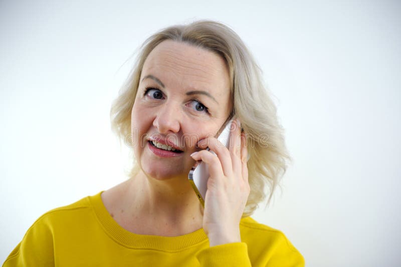 caucasian woman using smartphone typing message in shock face, looking skeptical and sarcastic, surprised with open mouth . High quality photo. caucasian woman using smartphone typing message in shock face, looking skeptical and sarcastic, surprised with open mouth . High quality photo