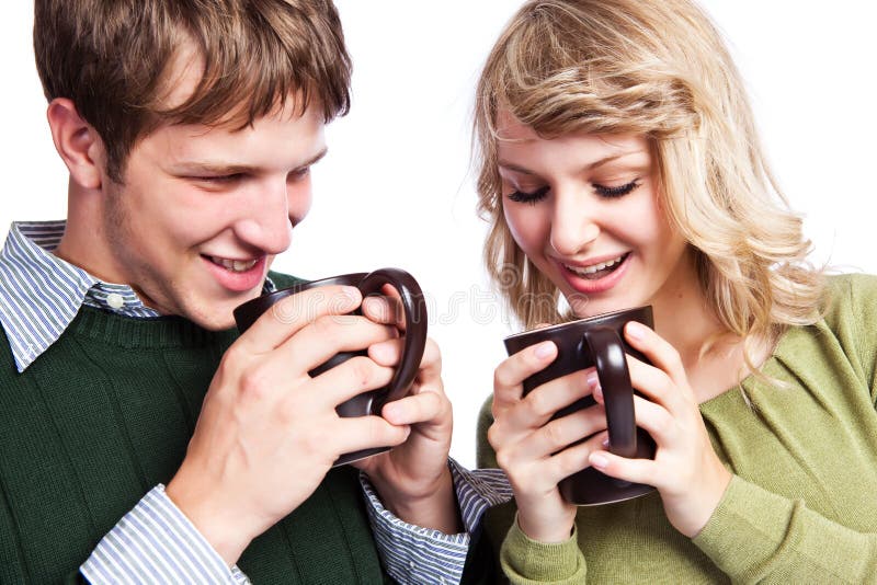 A portrait of a happy beautiful caucasian couple holding coffee cups. A portrait of a happy beautiful caucasian couple holding coffee cups