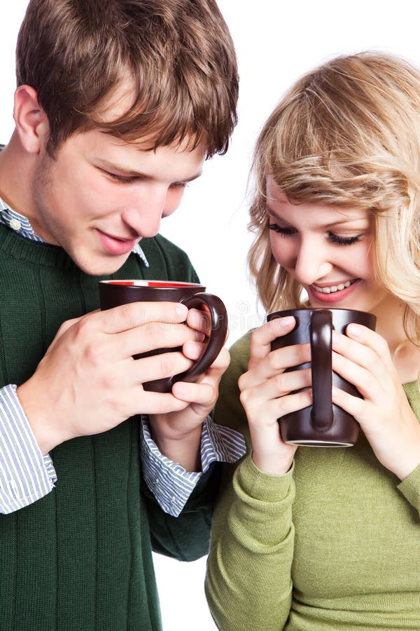 A portrait of a happy beautiful caucasian couple holding coffee cups. A portrait of a happy beautiful caucasian couple holding coffee cups