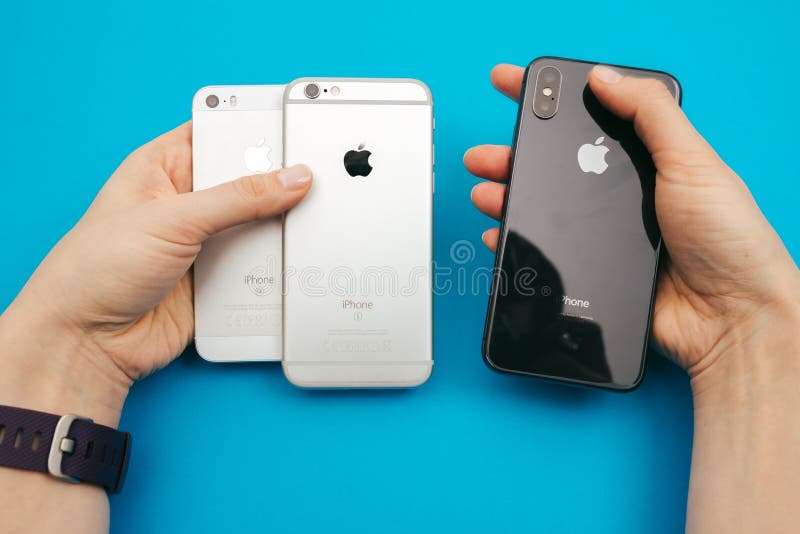 Holding in hands a new Apple iPphone X, iPhone SE and iPhone 6S