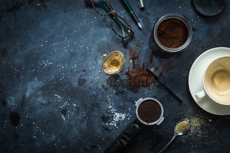 Cafe table - espresso accessories, empty coffee cup, glasses and pen. Writer`s desk scenery after night work concept. Flat lay layout captured from above top view. Background with free text space. Cafe table - espresso accessories, empty coffee cup, glasses and pen. Writer`s desk scenery after night work concept. Flat lay layout captured from above top view. Background with free text space.