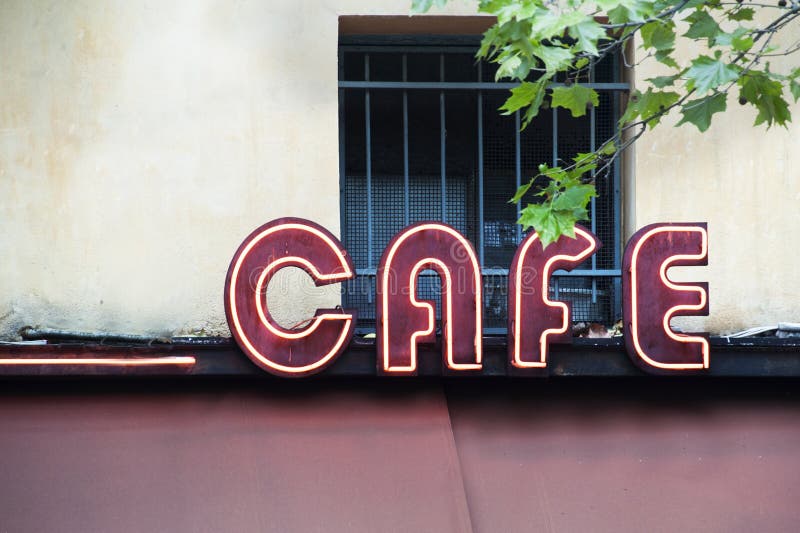 An illuminated cafe sign in Paris. An illuminated cafe sign in Paris