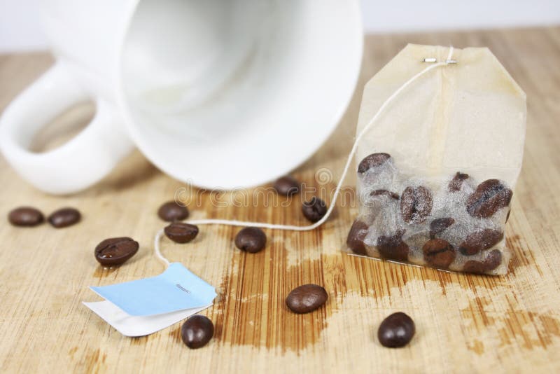 Coffeebeans in a teabag on a wooden underground. Coffeebeans in a teabag on a wooden underground