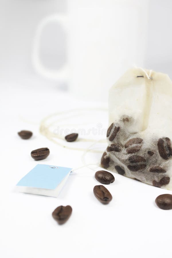 Coffeebeans in a teabag on white underground. Coffeebeans in a teabag on white underground