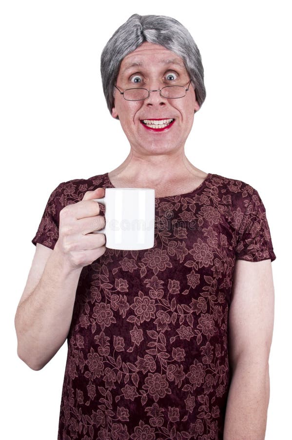 Funny ugly mature senior woman is drinking coffee. The old maid or grandma is a getting a caffeine buzz while she drinks java from her cup. The lady isolated on white. Funny ugly mature senior woman is drinking coffee. The old maid or grandma is a getting a caffeine buzz while she drinks java from her cup. The lady isolated on white.