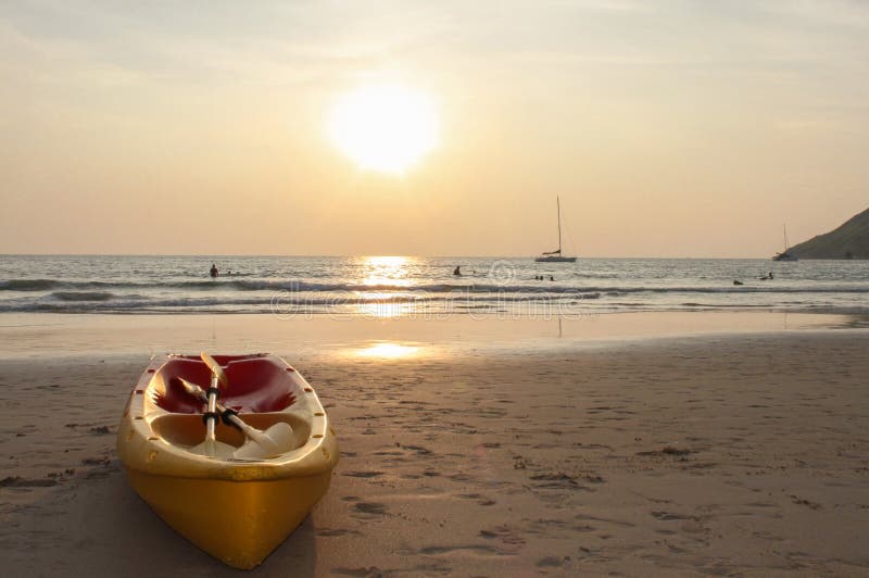 Kayak canoe boat on the beach during sunset stock photos