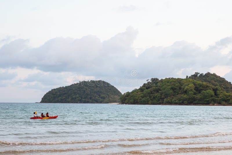 Kayak over the sea with green islands and blue, yellow sky in background in the evening in Koh Mak Island at Trat, Thailand royalty free stock photography Kayak over the sea with green islands and blue, yellow sky in background in the evening in Koh Mak Island at Trat, Thailand royalty free stock photography