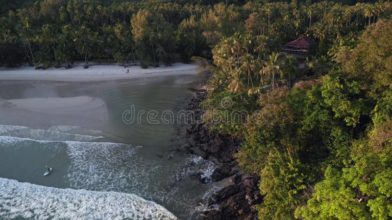 Kayak paddle boat through waves beach. Breathtaking aerial top view flight drone