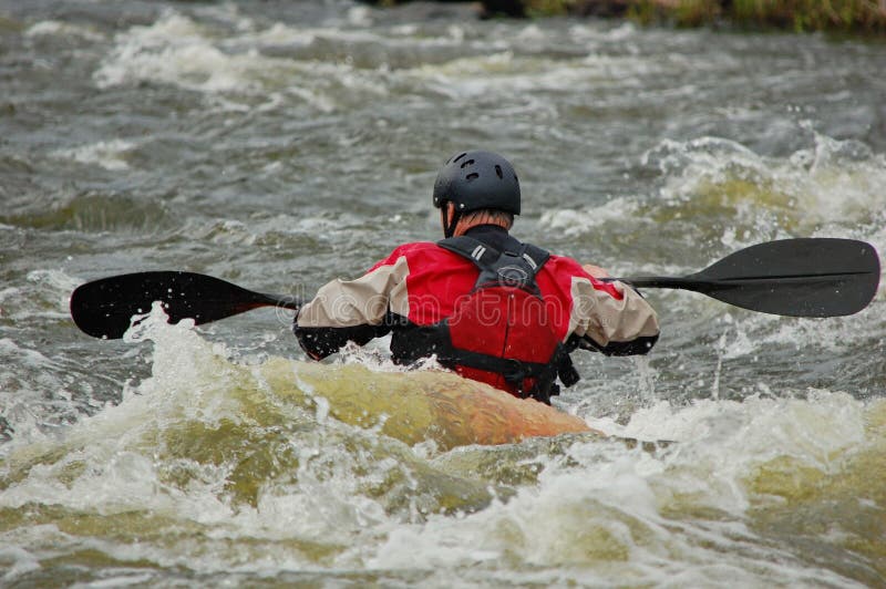 Kayaker training on a rough water.