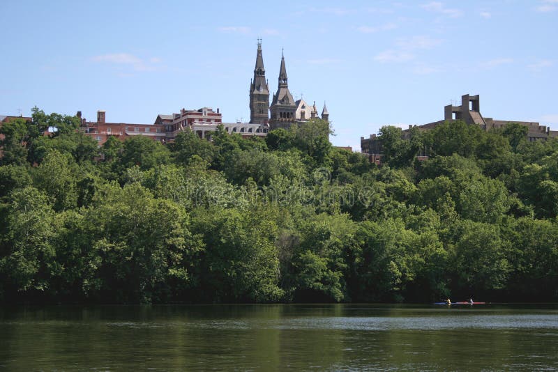 Kayakers in the Potomac, rowing in front of Georgetown University in the background. Image taken from a tour boat. Kayakers in the Potomac, rowing in front of Georgetown University in the background. Image taken from a tour boat.