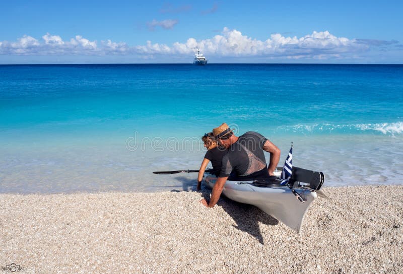 Kayakers op de kajak en een mooi jacht op de achtergrond van wolken op het Eiland Kefalonia in het Ionische Overzees in Griekenla royalty-vrije stock afbeeldingen Kayakers op de kajak en een mooi jacht op de achtergrond van wolken op het Eiland Kefalonia in het Ionische Overzees in Griekenla royalty-vrije stock afbeeldingen