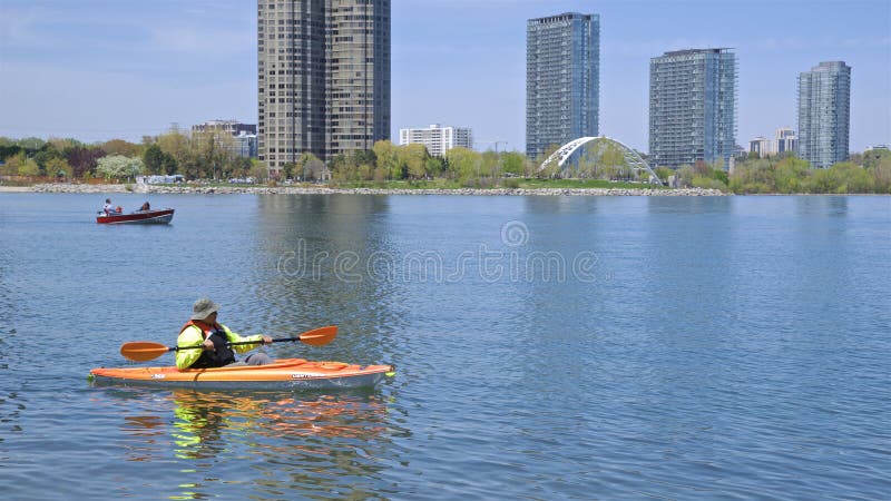Kayaking at Lake Ontario with waterfront apartments buildings as a background. Toronto, Ontario / Canada - 05/21/2018: kayaking at Lake Ontario with waterfront royalty free stock photos Kayaking at Lake Ontario with waterfront apartments buildings as a background. Toronto, Ontario / Canada - 05/21/2018: kayaking at Lake Ontario with waterfront royalty free stock photos