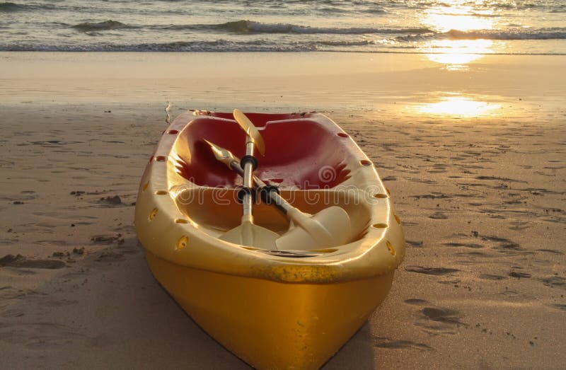 Kayaks canoe boat on the beach during sunset stock photos