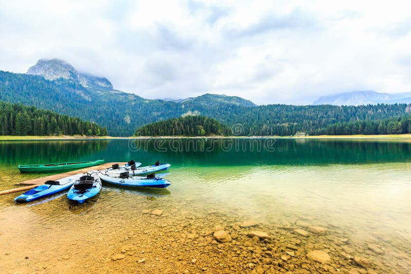 Kayaks docked on the shore of Black Lake. Mountain landscape, Durmitor National Park, Zabljak, Montenegro.