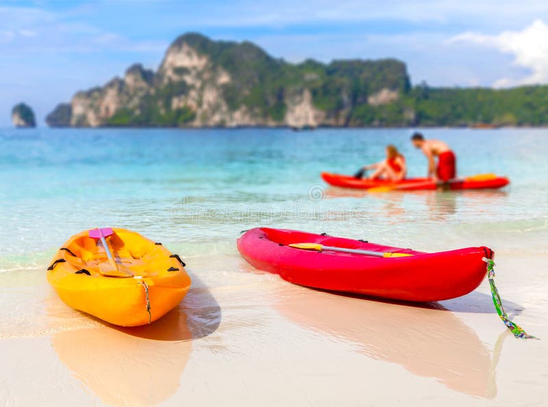 Kayaks on a tropical beach, shallow depth of field.