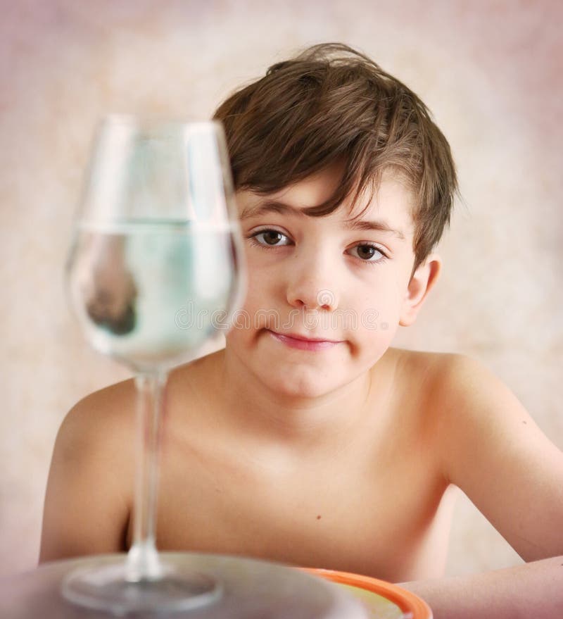 Keen preteen boy investigate reflection behavior in water