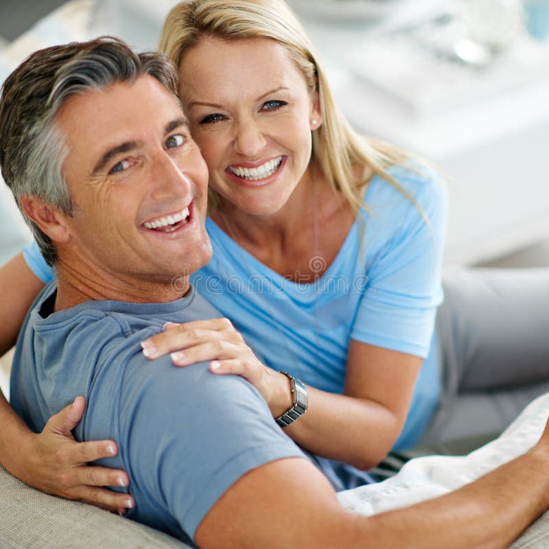 We Keep Each Other Smiling A Mature Couple Laughing While Relaxing At