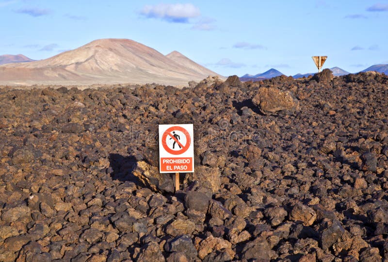 Keep-off sign in volcanic landscape of the Timanfaya National Park in Lanzarote