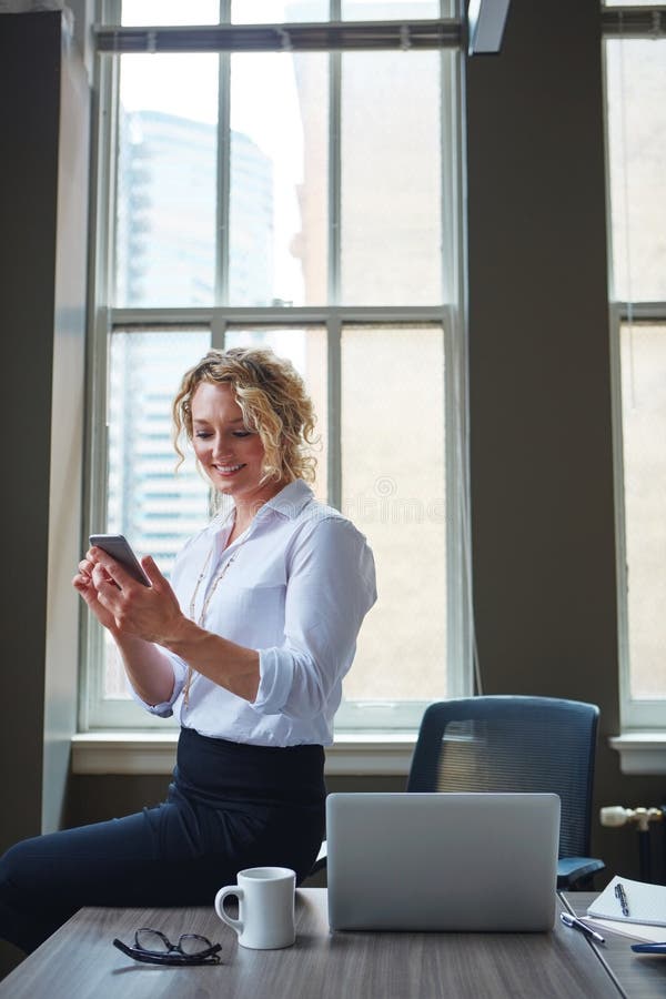 Keeping Track of Her Work Schedule Using Her Phone. a Businesswoman
