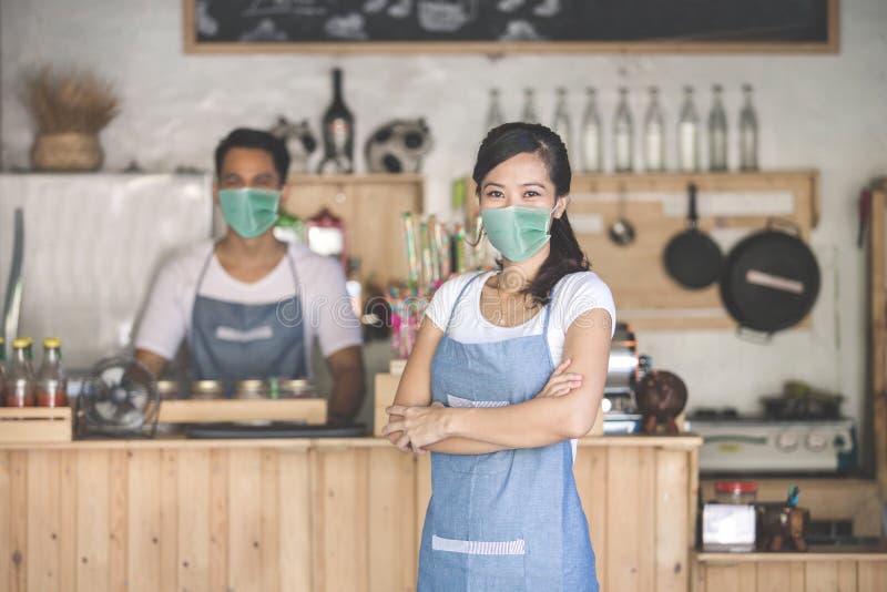 Portrait of waitress at the shop wear face masks. Portrait of waitress at the shop wear face masks