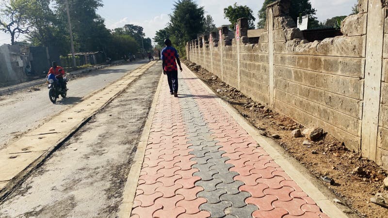 Kenyan roads, bodaboda on local road construction with tile pavements  Ziwani in Starehe Constituency in  Nairobi Kenya