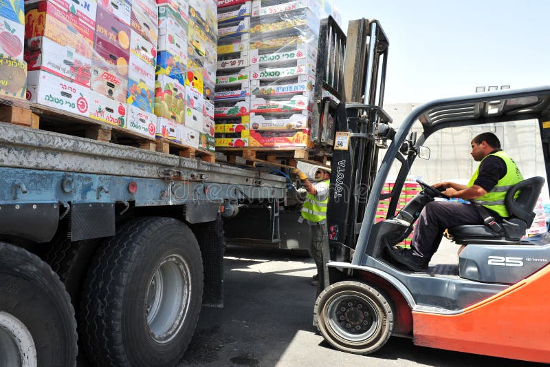 KEREM SHALOM, ISR - JUNE 21:Cargo entering Gaza at Kerem Shalom crossing on June 21 2009. The crossing is used by trucks carrying goods from Israel to the Gaza Strip. In 2012, the rate of traffic was 250 trucks a day. KEREM SHALOM, ISR - JUNE 21:Cargo entering Gaza at Kerem Shalom crossing on June 21 2009. The crossing is used by trucks carrying goods from Israel to the Gaza Strip. In 2012, the rate of traffic was 250 trucks a day.