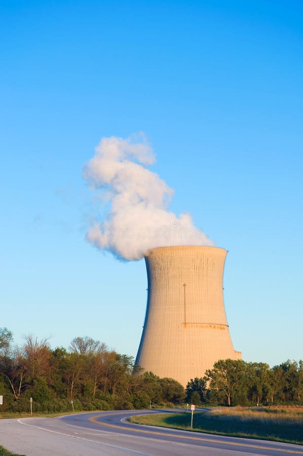 A nuclear reactor cooling tower with steam coming out. A nuclear reactor cooling tower with steam coming out