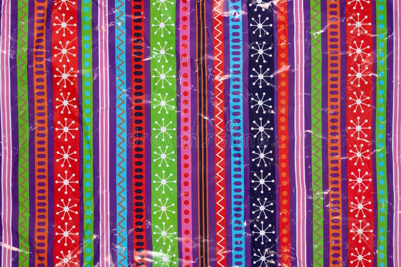 White snowflakes and geometric patterns on a multicolored background wrapping paper. Christmas Holiday concept. White snowflakes and geometric patterns on a multicolored background wrapping paper. Christmas Holiday concept