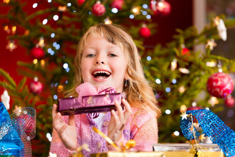 Christmas - happy little girl with Xmas present on Christmas Eve. Christmas - happy little girl with Xmas present on Christmas Eve