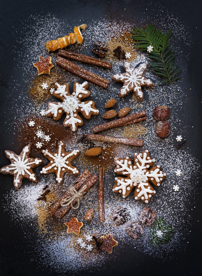 Kerstmis of Nieuwjaarachtergrond van Peperkoekkoekjes, kruiden, noten met suiker en sneeuwvlokken Hoogste mening royalty-vrije stock afbeelding Kerstmis of Nieuwjaarachtergrond van Peperkoekkoekjes, kruiden, noten met suiker en sneeuwvlokken Hoogste mening royalty-vrije stock afbeelding