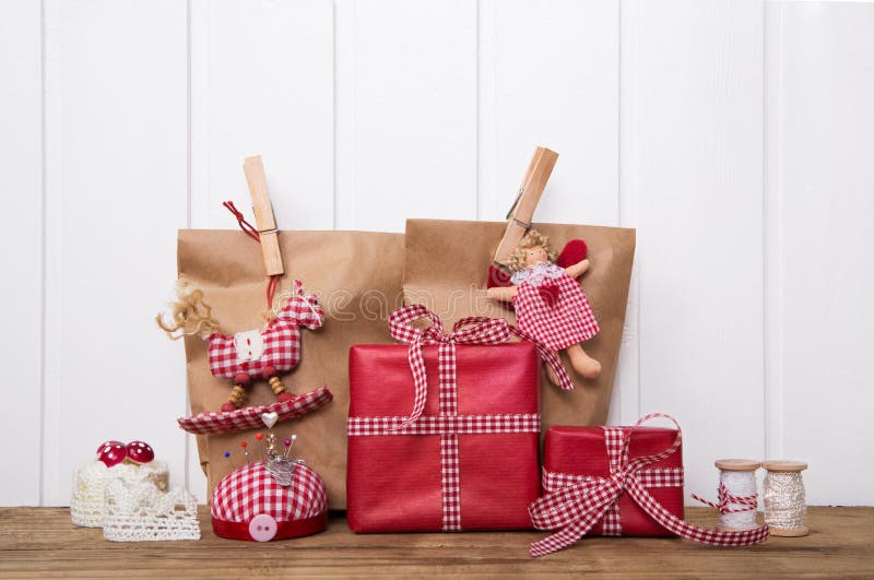 Kerstmis stelt verpakt in document zakken met rood gecontroleerd wit voor