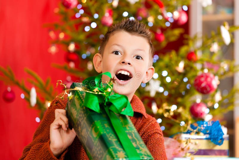 Christmas - happy little boy with Xmas present on Christmas Eve. Christmas - happy little boy with Xmas present on Christmas Eve