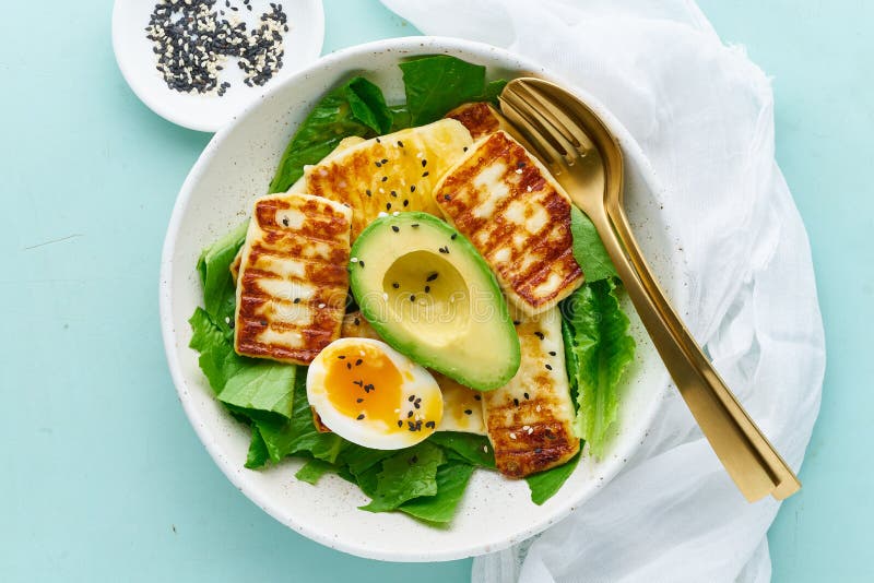 Keto Ketogenic Diet Soft Boiled Eggs with Avocado and Lettuce on Pastel