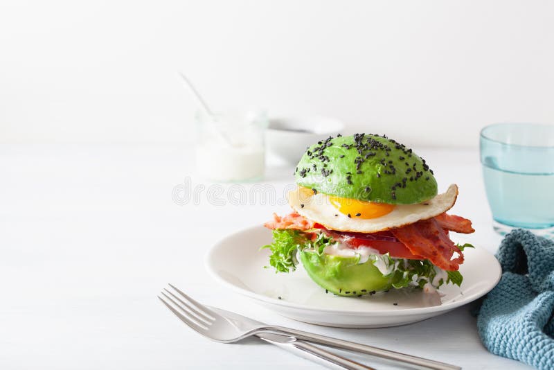 Keto Paleo Diet Avocado Breakfast Burger with Bacon, Egg, Tomato Stock