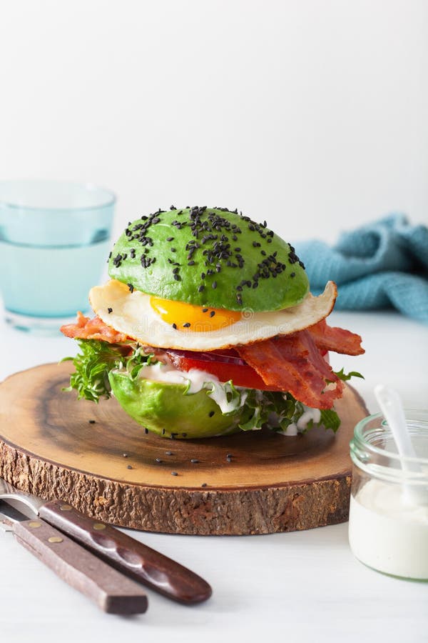 Keto Paleo Diet Avocado Breakfast Burger with Bacon, Egg, Tomato Stock