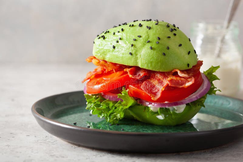 Keto Paleo Diet Avocado Burger with Bacon, Lettuce, Tomato Stock Image