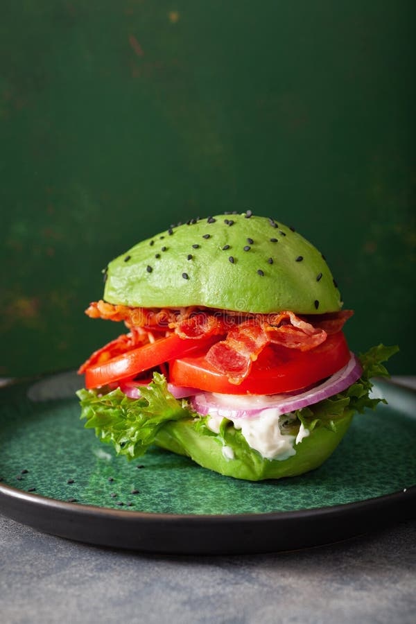Keto Paleo Diet Avocado Burger with Bacon, Lettuce, Tomato Stock Photo