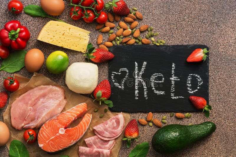 Ketogenic diet food. Healthy low carbs products.Keto diet concept. Vegetables, fish, meat, nuts, seeds, strawberries, cheese on a
