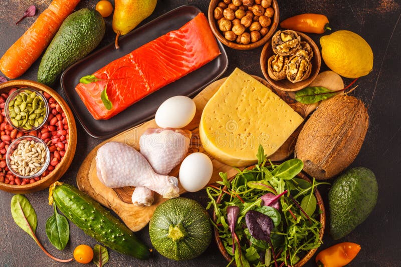 Keto diet concept. Balanced low-carb food background. Vegetables, fish, meat, cheese, nuts on a dark background. Keto diet concept. Balanced low-carb food background. Vegetables, fish, meat, cheese, nuts on a dark background.