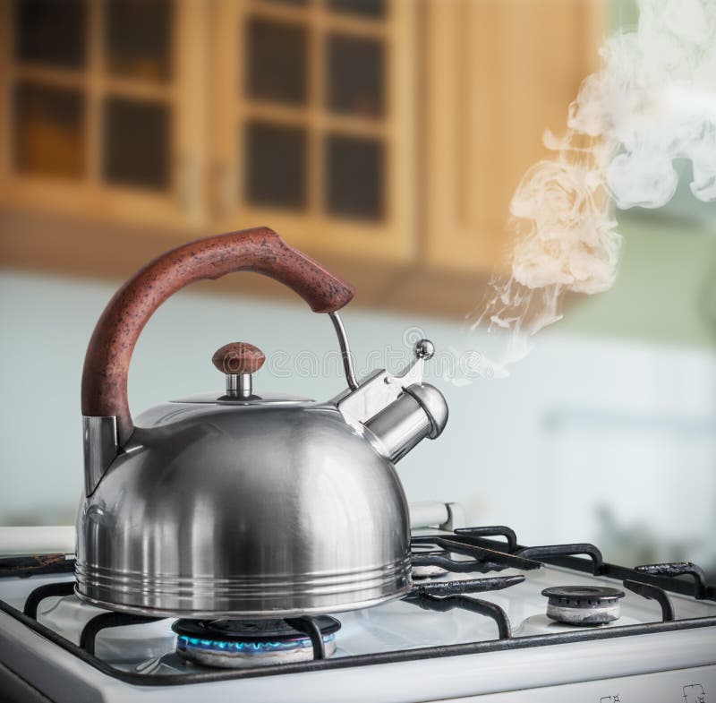 Kettle boiling on a gas stove in the kitchen stock images Kettle boiling on a gas stove in the kitchen stock images