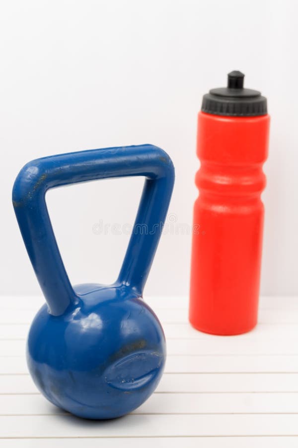 Kettlebell and Water Bottle on a White Wooden Floor Stock Photo Image