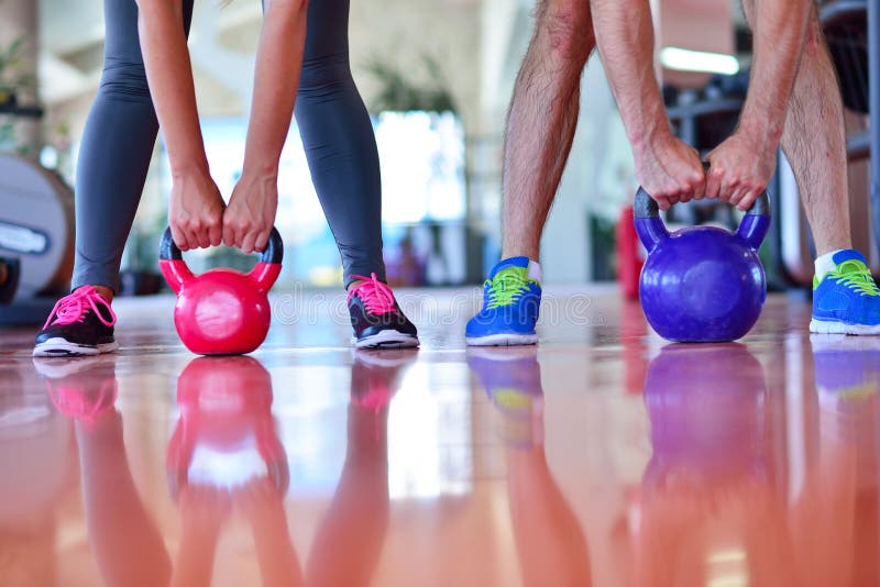 Kettlebells Swing Exercise Man and Woman Workout at Gym Stock Image