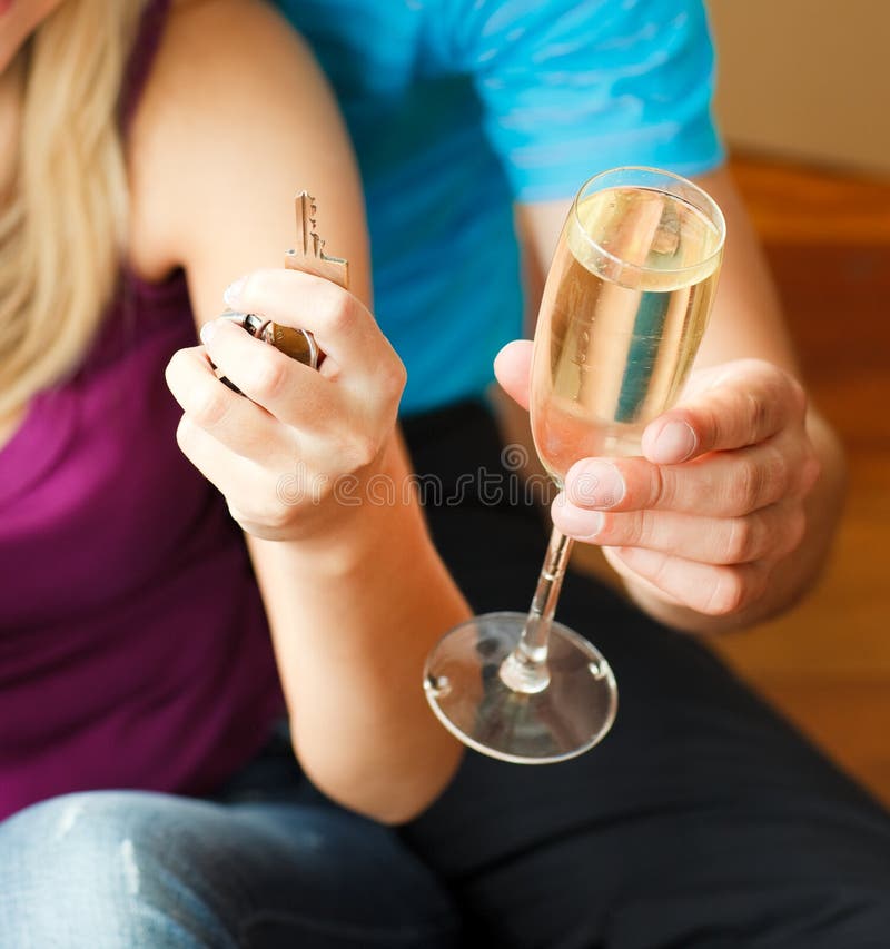 A key and a glass of champagne.