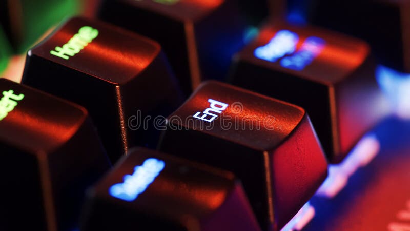 Keyboard key - End - macro shot. Modern gaming keyboard close-up with beautiful color backlight. Macro shooting of the rgb computer keyboard with backlight. Low angle view with soft focus