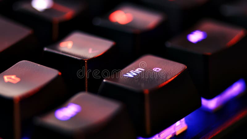 Keyboard key - Windows - macro shot. Modern gaming keyboard close-up with beautiful color backlight. Macro shooting of the rgb computer keyboard with backlight. Low angle view with soft focus