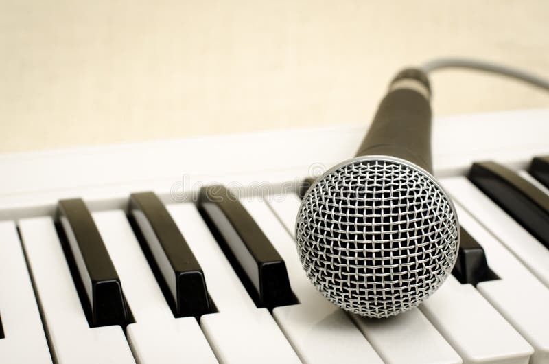 Microphone And Piano Keyboard On Black Table Stock Photo - Image of