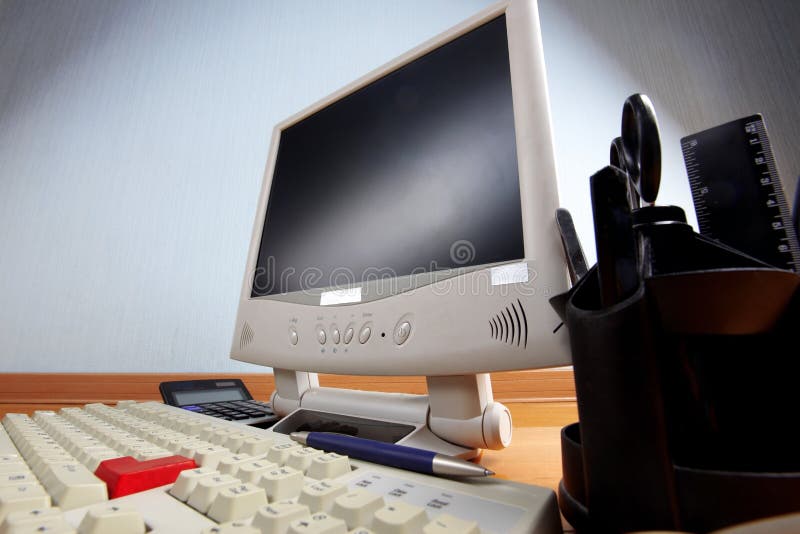 Keyboard and monitor at table stock images