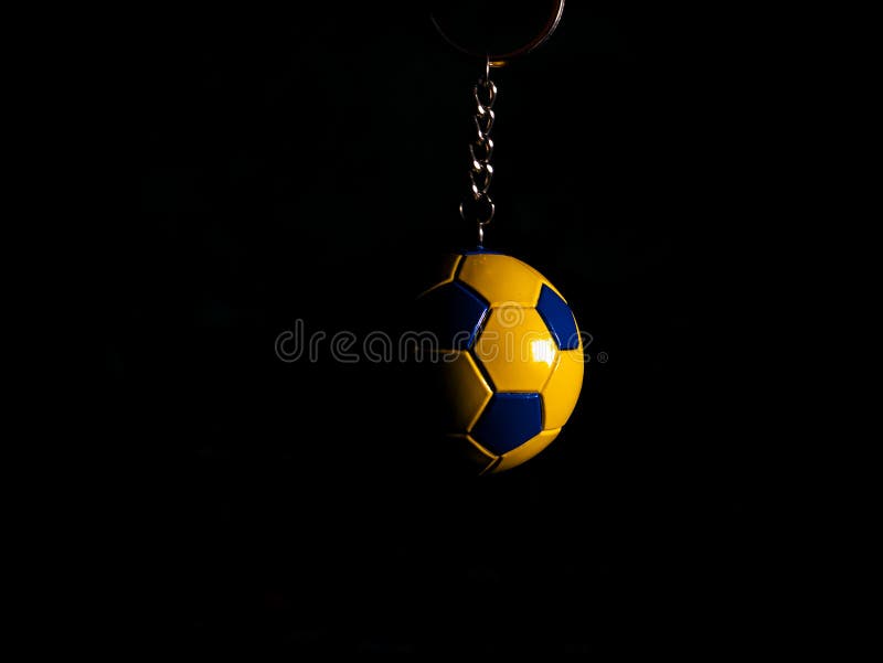 Keychain for a football player or fan yellow and football shoes black trailer football silver