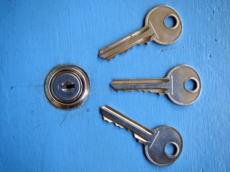 Keys and a keyhole on a blue door stock image