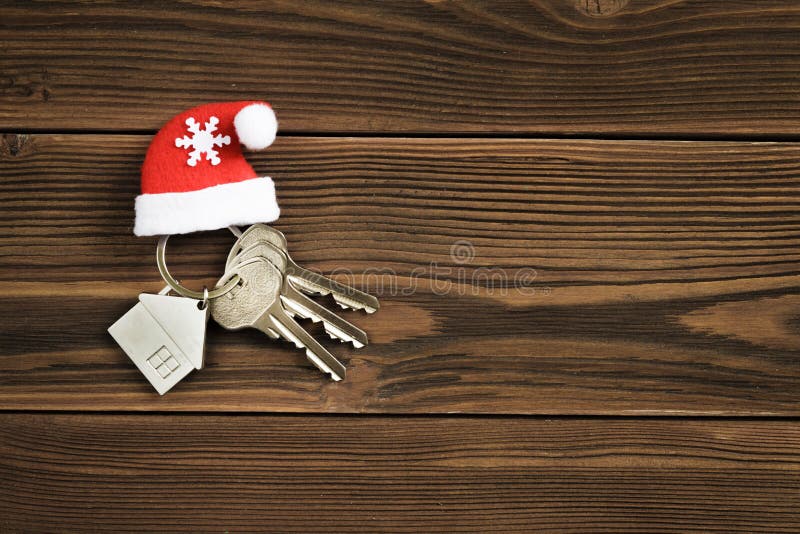 The keys to the house lie on a dark wooden background. The concept of buying an apartment